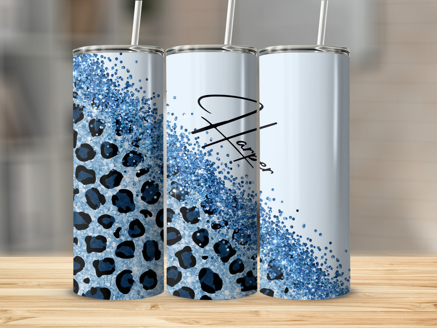 Three tumblers with leopard print and blue glitter design.