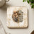 Square coaster with watercolor lion and cross, text "The Lion of Judah".
