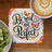 Coaster with "Be real not perfect" text and butterflies, next to kiwi and coffee.