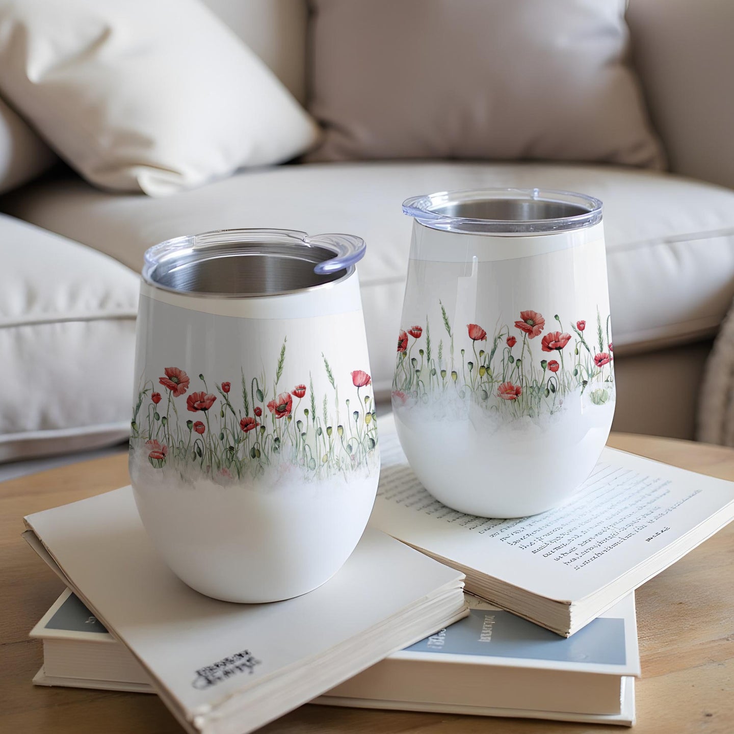Two white tumblers with red poppies and green grass pattern.