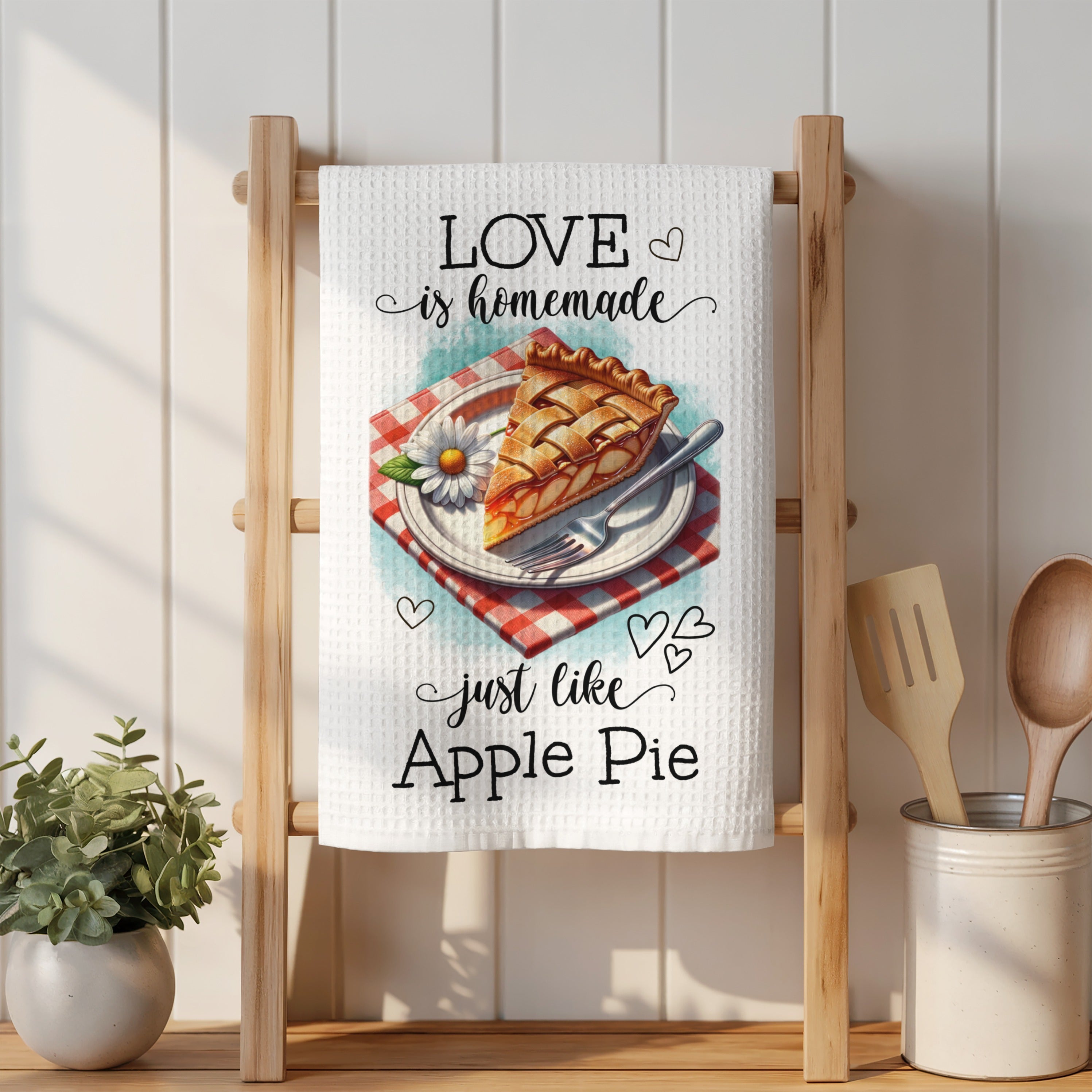 Towel with "Love is homemade just like Apple Pie" and pie illustration.