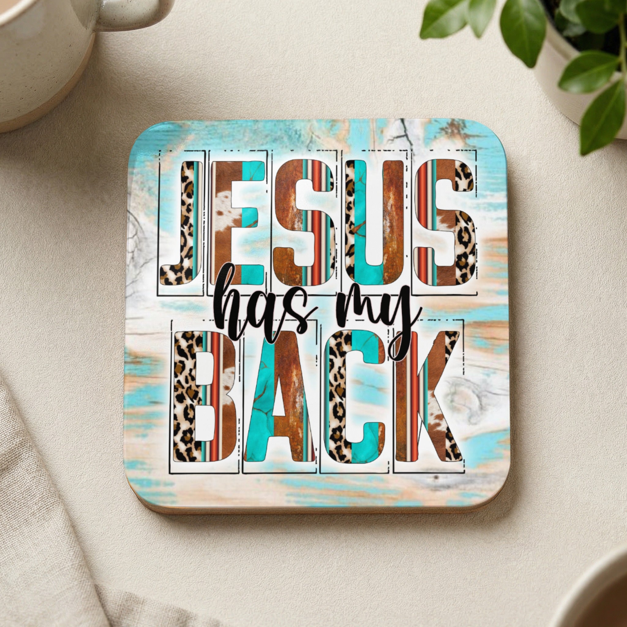Coaster with "JESUS HAS MY BACK" text and wood, leopard, and turquoise patterns.