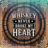 Whiskey Never Broke My Heart text on a wooden barrel background.