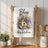 White kitchen towel with "Bless this kitchen" and birdhouse watercolor design.