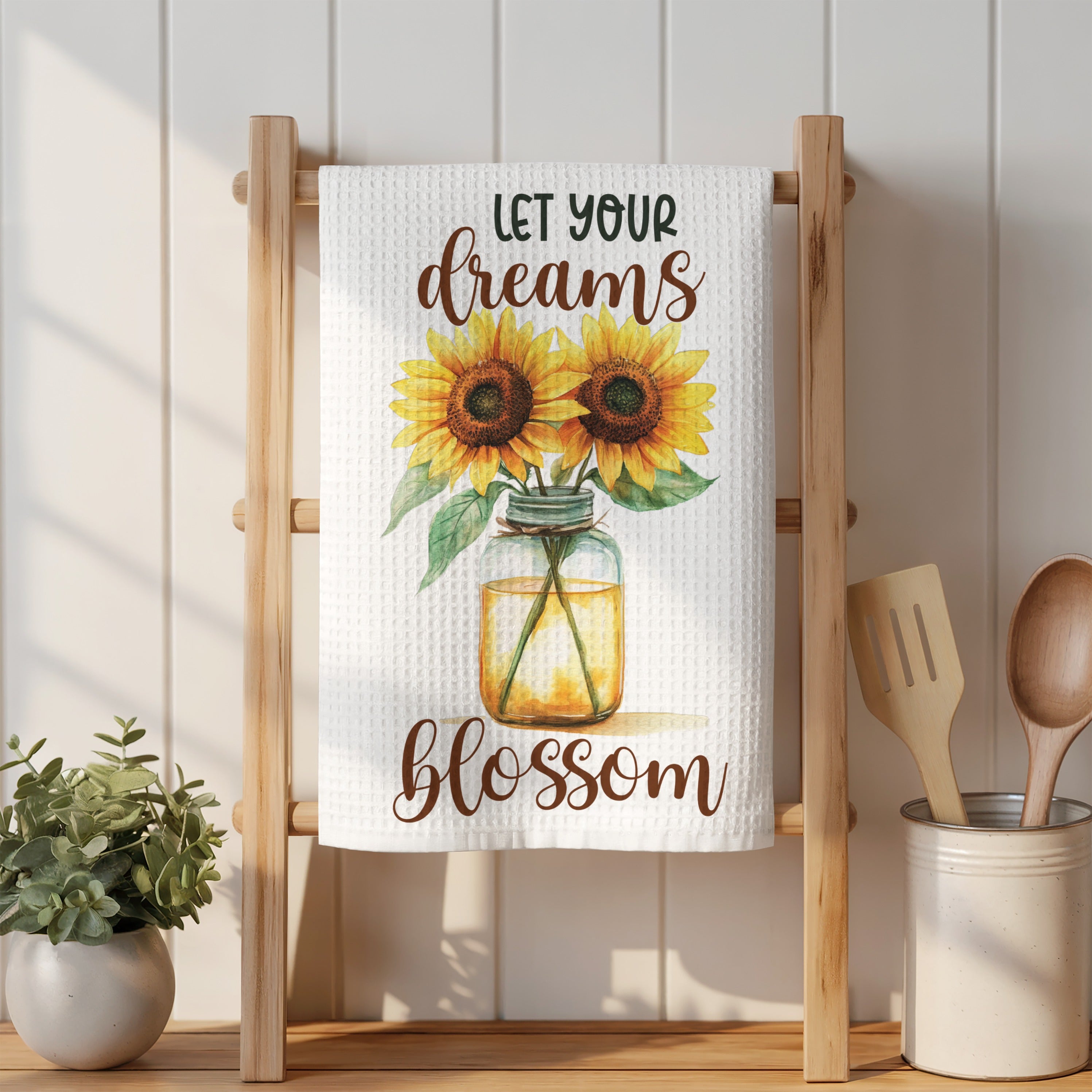 Sunflower design on a white waffle weave kitchen towel.