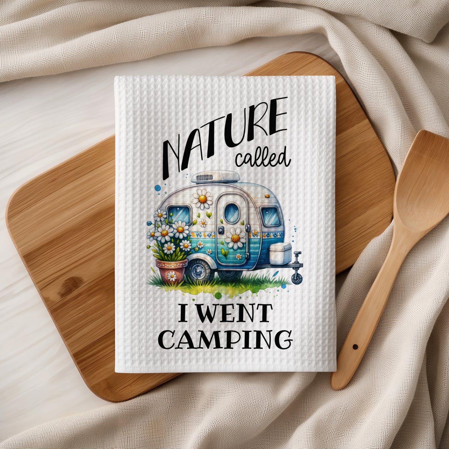 White kitchen towel with camper and flowers graphic and text.