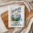 White kitchen towel with camper and flowers graphic and text.