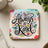 Square coaster with "Always Be Kind" text and colorful butterflies.