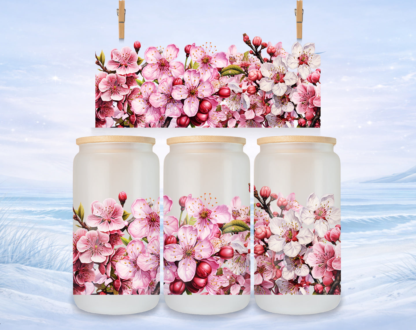 Three glass jars with cherry blossom floral design against a winter landscape.