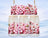 Three glass jars with cherry blossom floral design against a winter landscape.