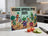 Cutting board with "VEGGIE APOCALYPSE 2025" text and cartoon vegetables.