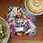 Woman with ombre hair wearing "Hot Mess" hoodie on a coaster next to coffee.