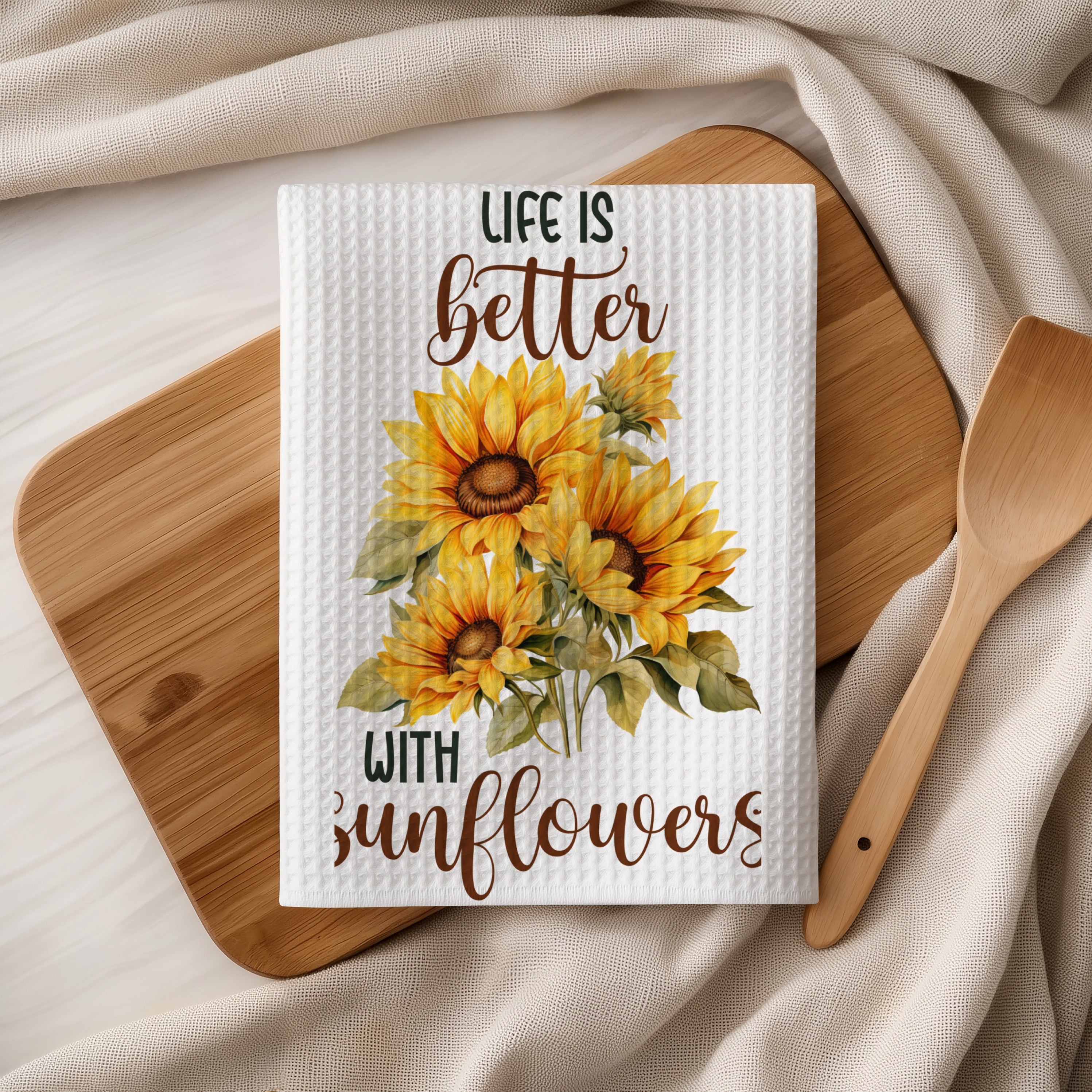 White waffle weave towel with painted sunflowers and "Life is better with sunflowers" text.