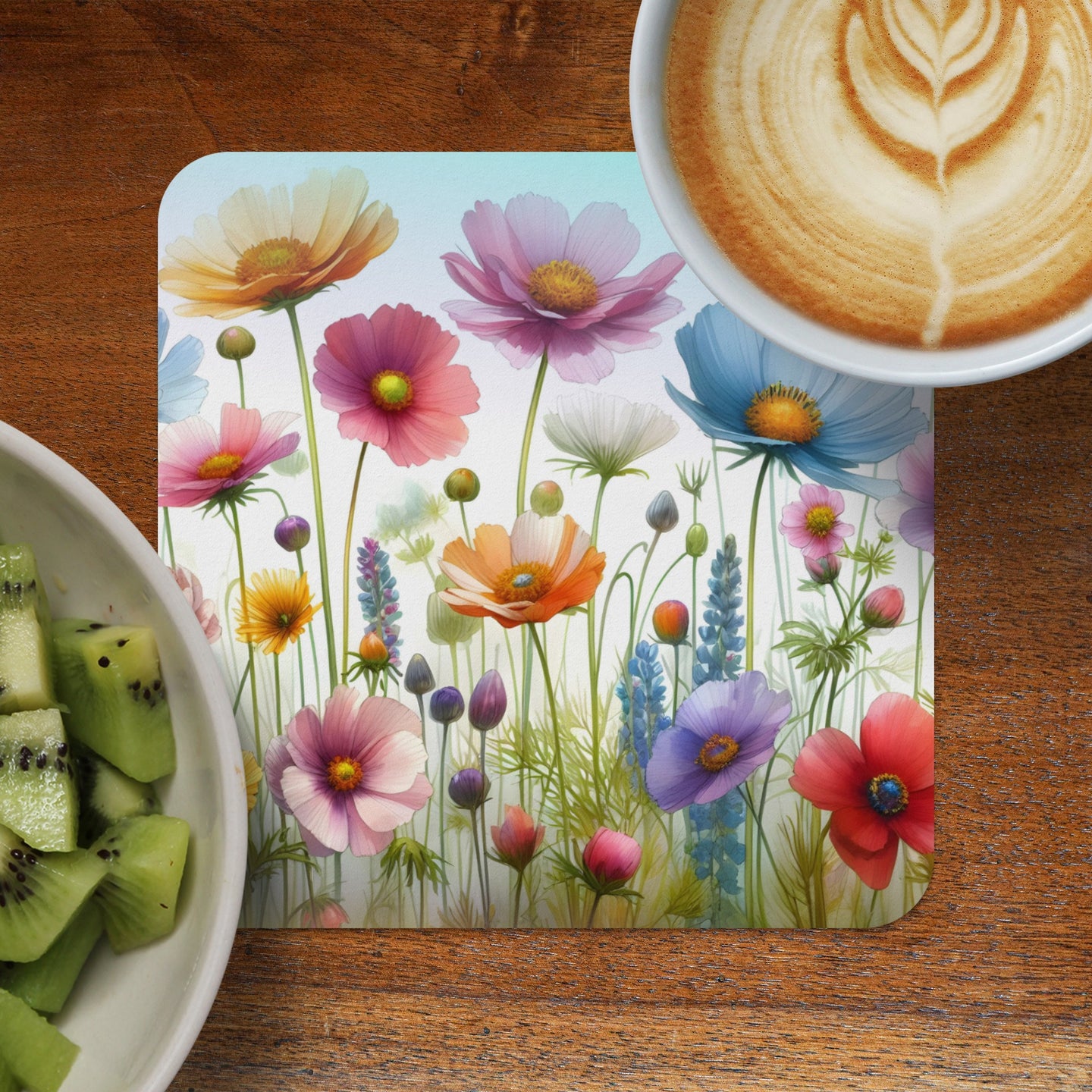 Floral pattern square coaster with latte and kiwi fruit.