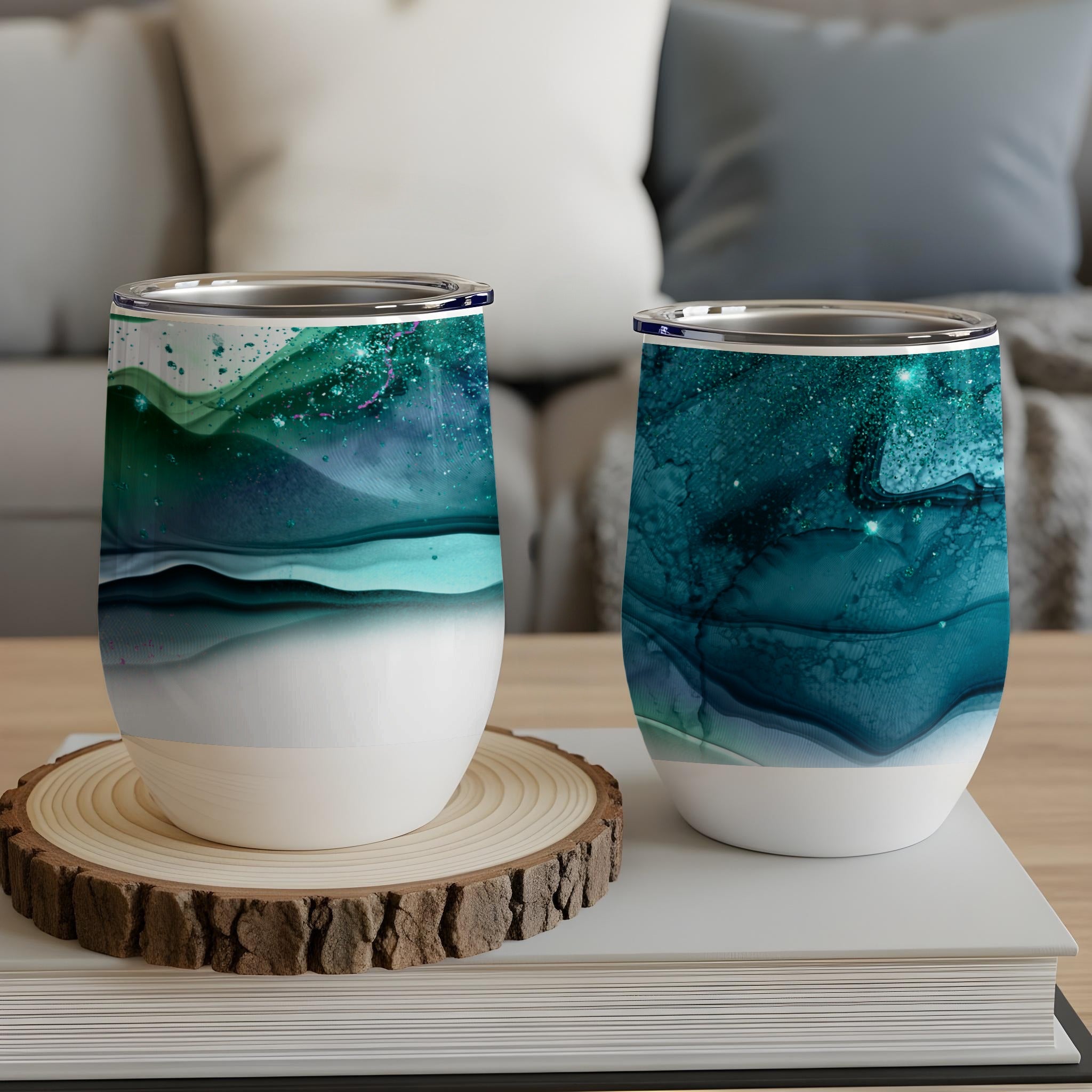 Two insulated wine tumblers with abstract teal and green watercolor designs.