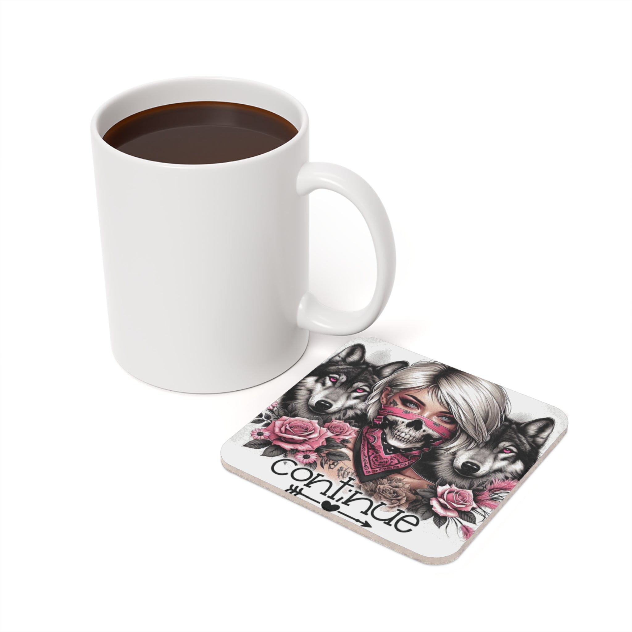 White mug of coffee next to a coaster with wolves and pink roses.