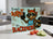 Raccoon in apron holding toast that says "It ain't burnt, it's blackened!"