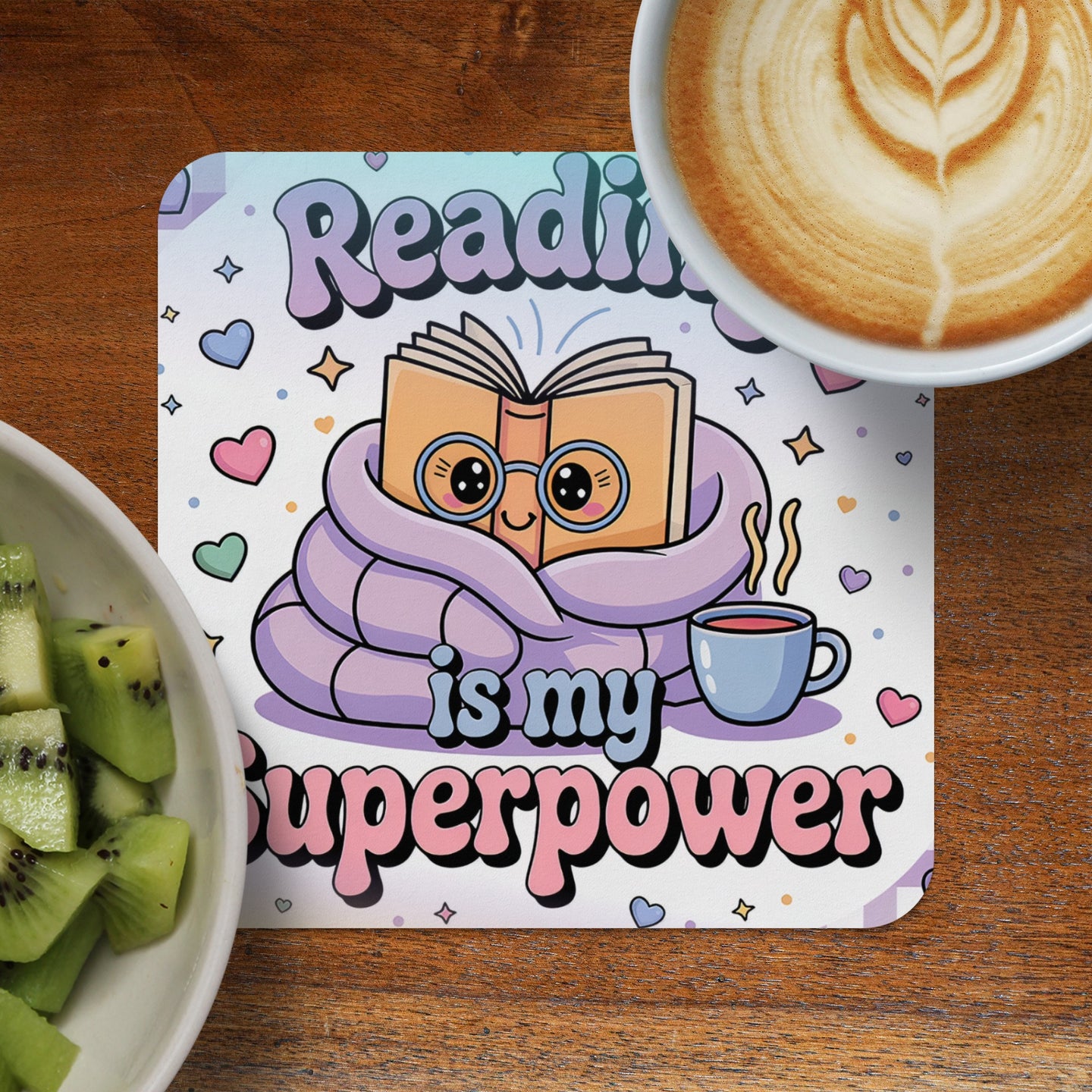 Coaster with cartoon book wrapped in blanket, text "Reading is my superpower".