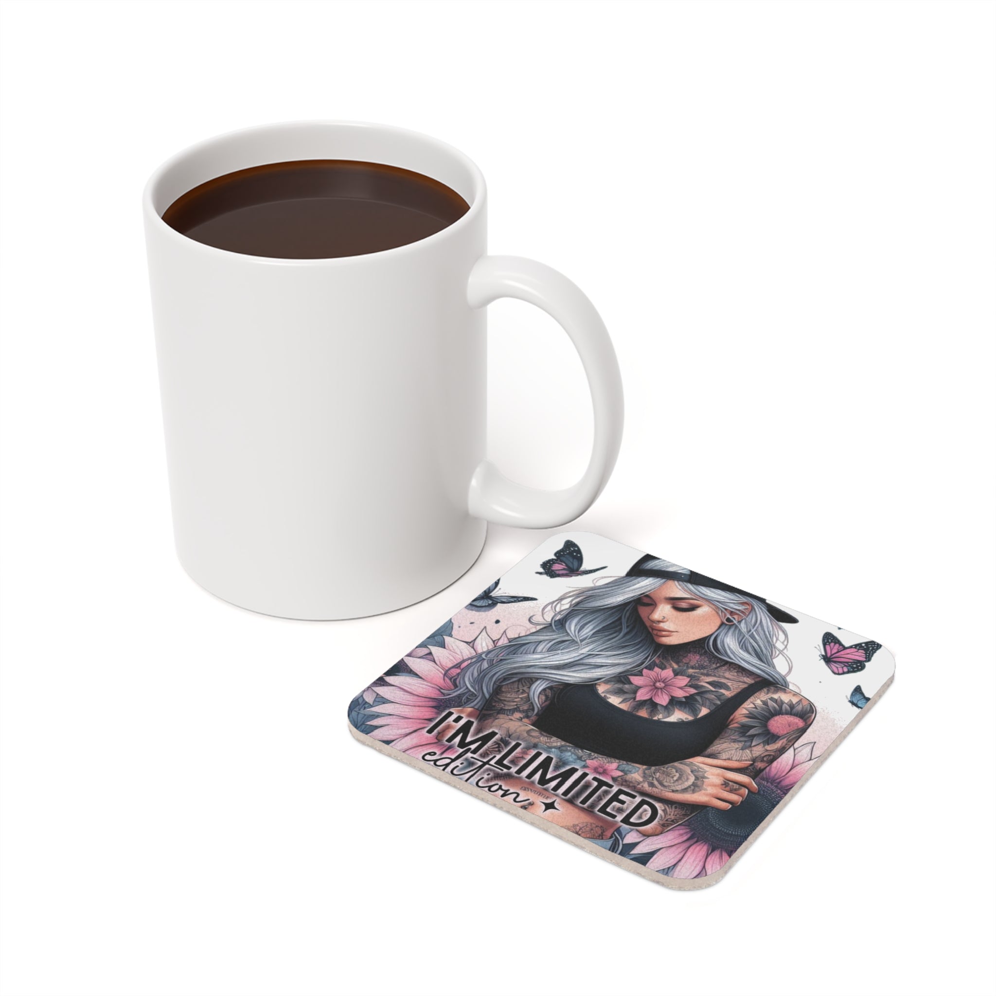 White mug with coffee next to a square coaster featuring tattooed woman and butterflies.