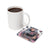 White mug with coffee next to a square coaster featuring tattooed woman and butterflies.