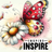 Red and yellow butterfly on a white daisy with "INSPIRE" text.