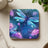 Blue iridescent dragonfly among glowing purple flowers and plants.